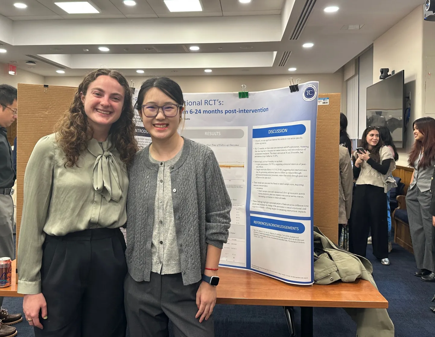 Abby (left) and Siqi (right) in front of their poster