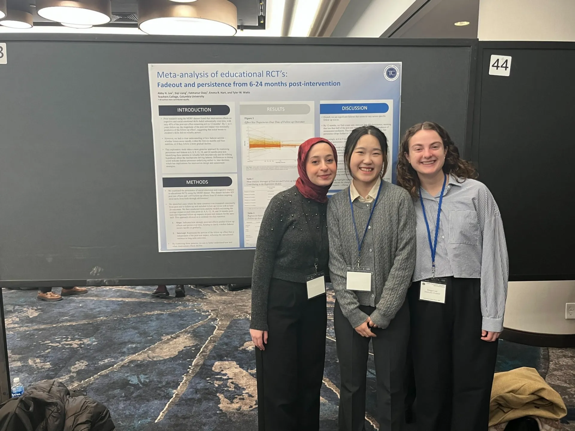 Fatmanur (Left), Siqi (Middle), and Abby (Right) in front of their poster