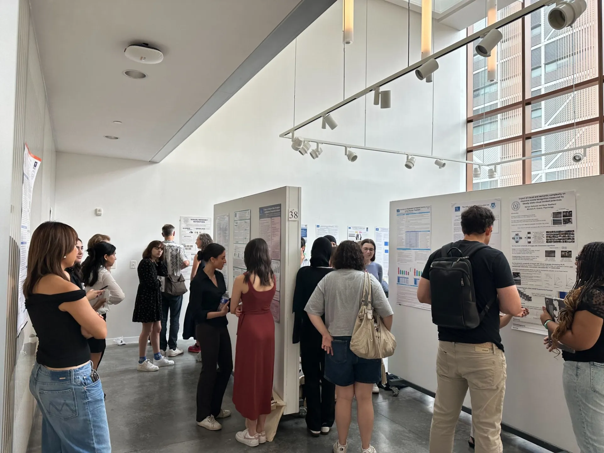 Several undergraduates presenting their respective posters at SRI.