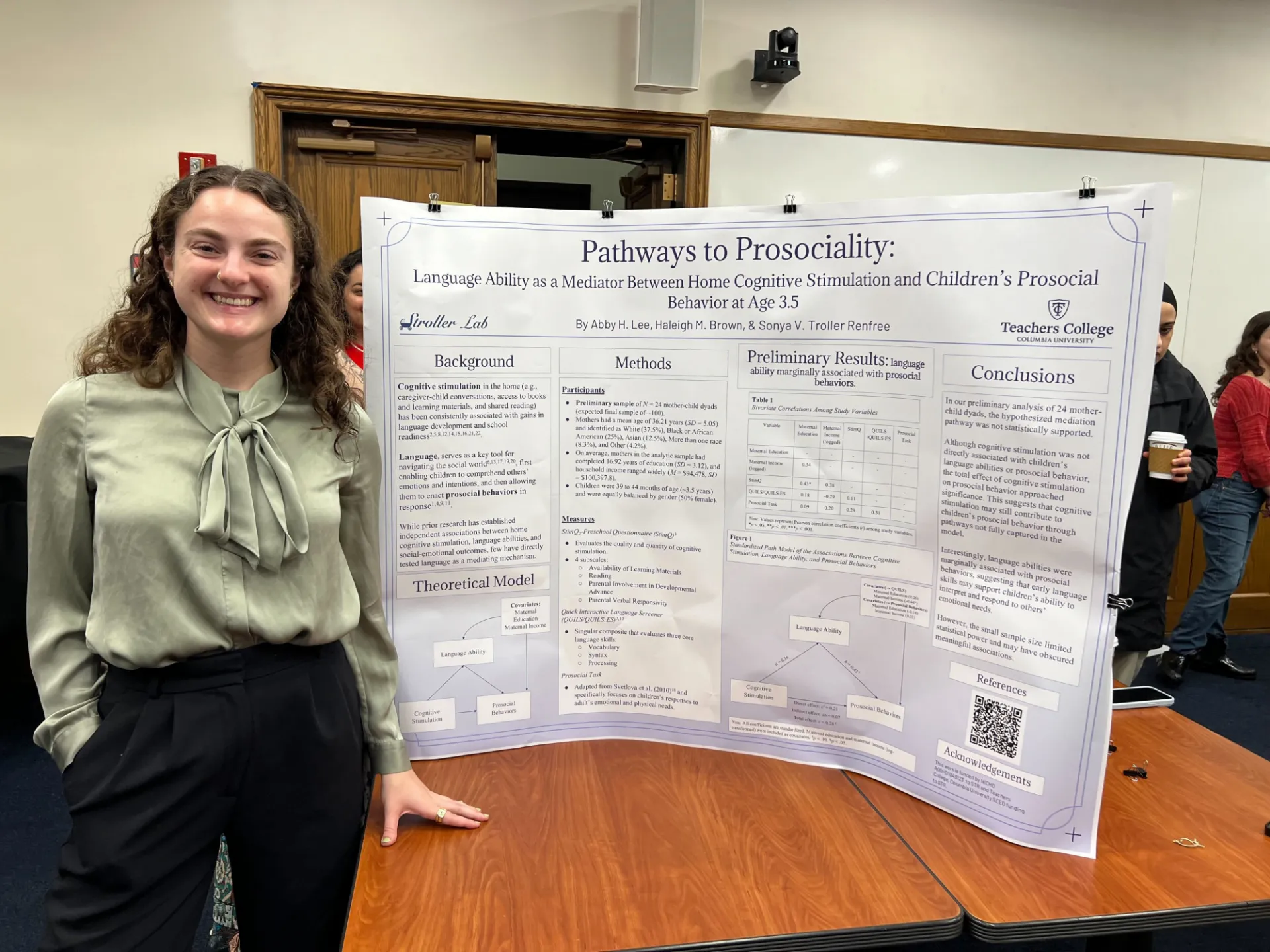 Abby in front of her poster